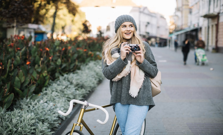 cheerful woman with bicycle camera