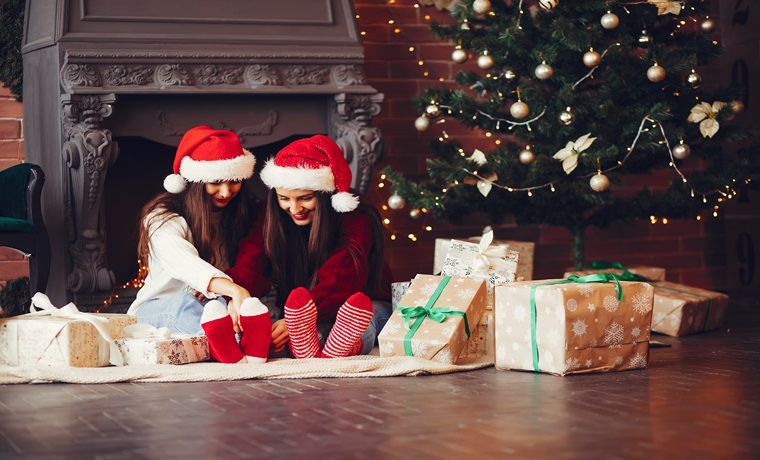 girls celebrationg christmas by exchanging gifts